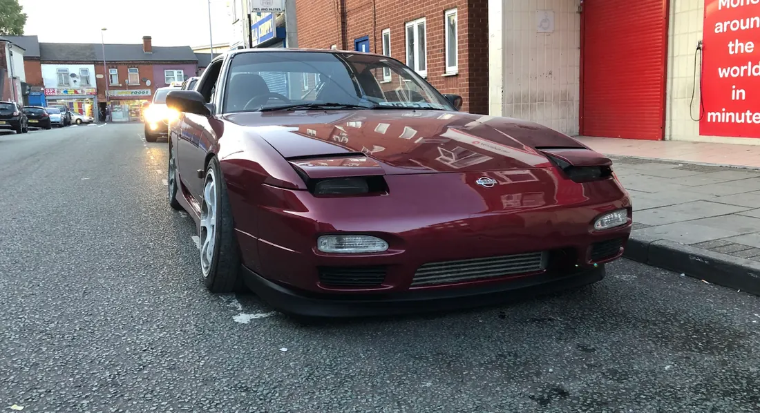Red sports car showing its bodywork and paint finish